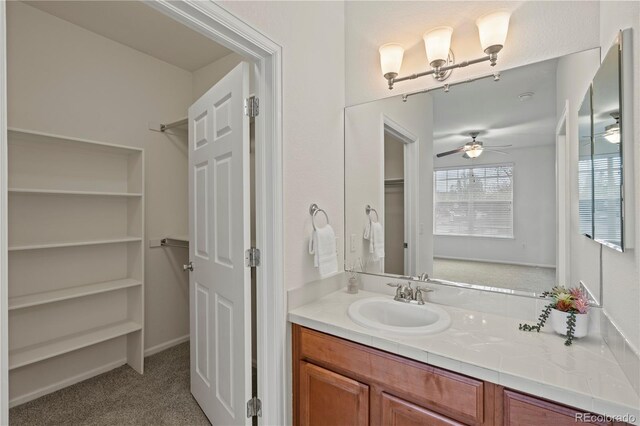 9907 Martin Luther King Blvd Unit 103, Denver, CO 80238 - bathroom featuring a ceiling fan, vanity, and a closet