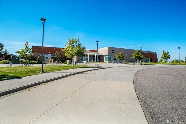 9907 Martin Luther King Blvd Unit 103, Denver, CO 80238 - view of concrete road with street lights, curbs, and sidewalks