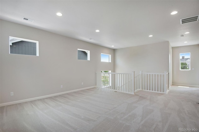 carpeted spare room with plenty of natural light