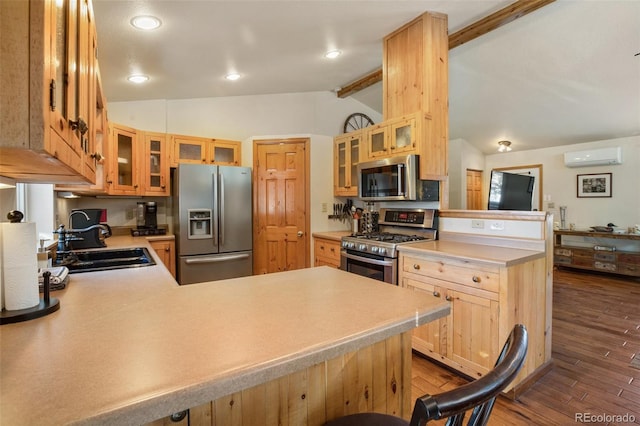 kitchen with sink, vaulted ceiling with beams, an AC wall unit, kitchen peninsula, and stainless steel appliances