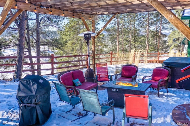 snow covered patio with a pergola, a grill, and a fire pit