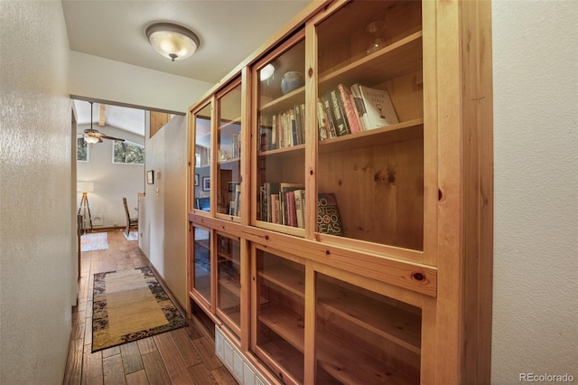 corridor with dark hardwood / wood-style flooring