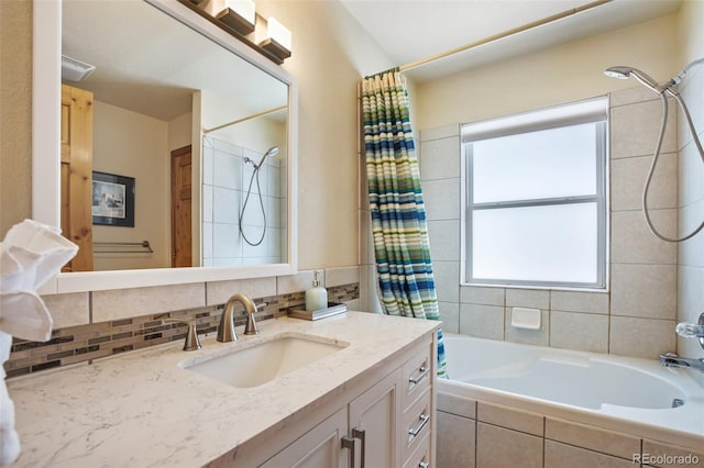 bathroom featuring tasteful backsplash, vanity, and shower / bath combo with shower curtain