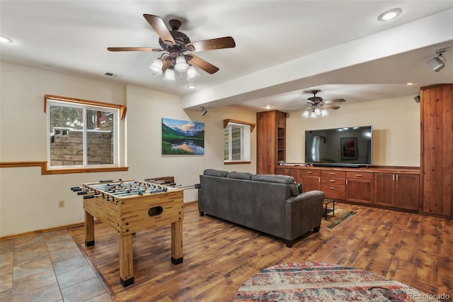 rec room featuring wood-type flooring and ceiling fan