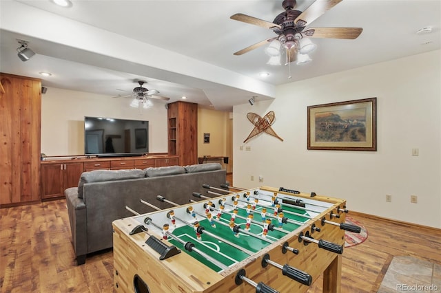 recreation room featuring ceiling fan and hardwood / wood-style floors