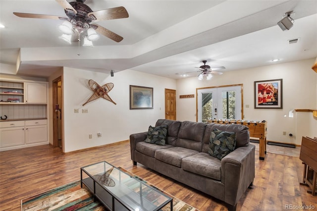 living room with ceiling fan, light wood-type flooring, and french doors