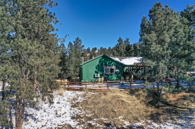 view of snow covered back of property