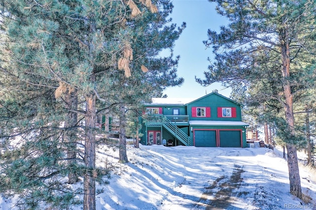 view of front of home with a garage and a wooden deck