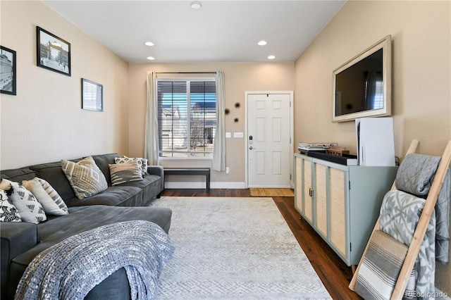 living room featuring dark wood finished floors, recessed lighting, and baseboards