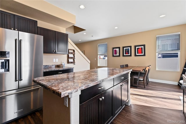 kitchen featuring recessed lighting, dark wood-style floors, high end fridge, and baseboards