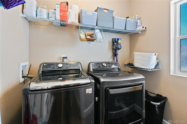 clothes washing area with laundry area and separate washer and dryer