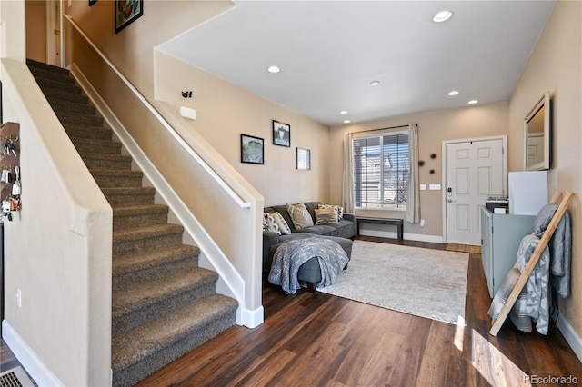 entrance foyer with stairway, recessed lighting, dark wood-style flooring, and baseboards