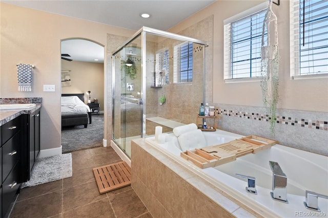 ensuite bathroom with vanity, a ceiling fan, a shower stall, a garden tub, and connected bathroom