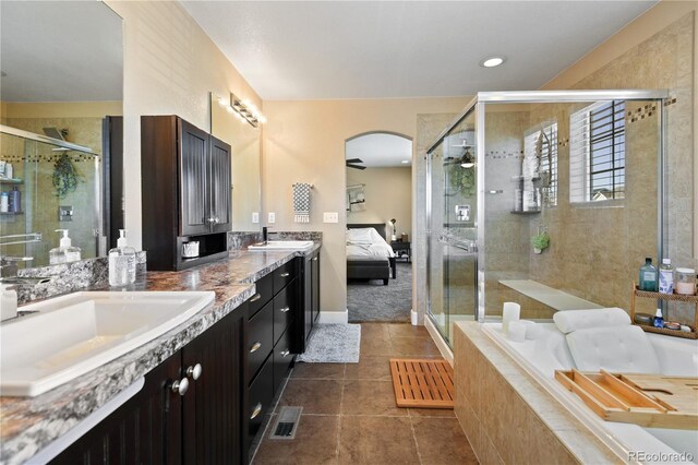 full bathroom featuring visible vents, double vanity, a sink, a shower stall, and a bath