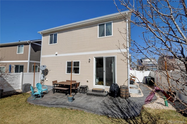 back of property with a yard, a patio, central AC, and a fenced backyard