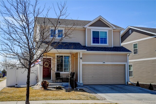 view of front of house with concrete driveway, an attached garage, board and batten siding, and a front yard