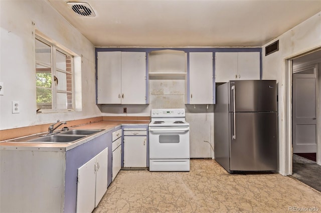 1000 Salem St, Aurora, CO 80011 - kitchen with freestanding refrigerator, white electric range oven, a sink, and light countertops