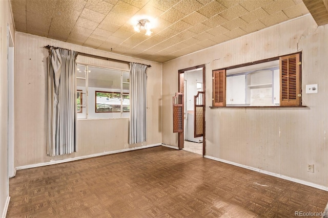 1000 Salem St, Aurora, CO 80011 - spare room with baseboards and wooden walls