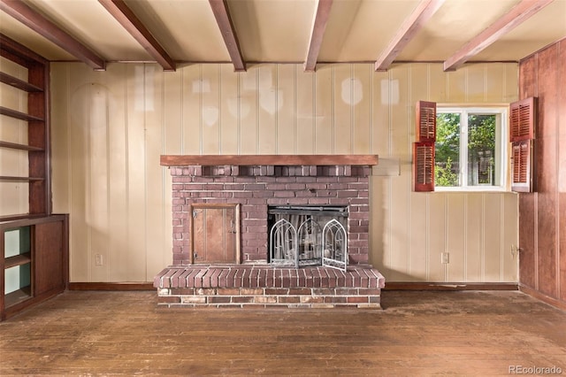 1000 Salem St, Aurora, CO 80011 - unfurnished living room featuring hardwood / wood-style floors, beam ceiling, a fireplace, baseboards, and wood walls
