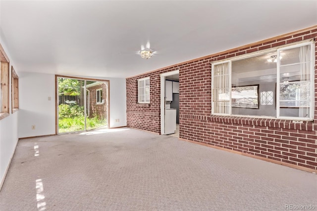 1000 Salem St, Aurora, CO 80011 - spare room featuring brick wall, carpet, and baseboards