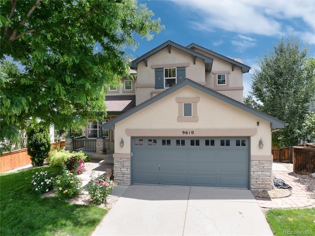 9610 S Dover Way, Littleton, CO 80127 - view of front of property with stone siding, stucco siding, and concrete driveway