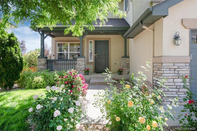 9610 S Dover Way, Littleton, CO 80127 - entrance to property featuring covered porch, stucco siding, and stone siding