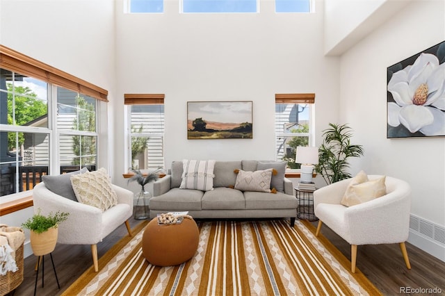 9610 S Dover Way, Littleton, CO 80127 - living area featuring wood finished floors, a towering ceiling, and healthy amount of natural light