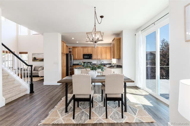 9610 S Dover Way, Littleton, CO 80127 - dining area featuring healthy amount of natural light, a chandelier, wood finished floors, and recessed lighting