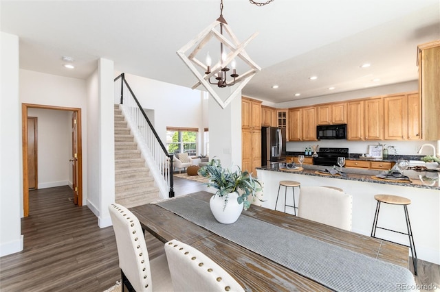 9610 S Dover Way, Littleton, CO 80127 - kitchen featuring black appliances, glass insert cabinets, a chandelier, wood finished floors, and recessed lighting