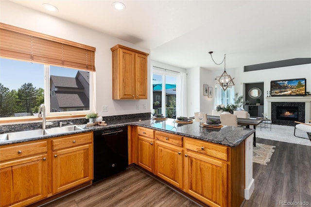 9610 S Dover Way, Littleton, CO 80127 - kitchen with black dishwasher, a peninsula, open floor plan, dark wood finished floors, and dark stone counters