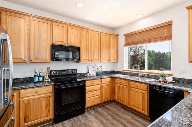 9610 S Dover Way, Littleton, CO 80127 - kitchen with black appliances, wood finished floors, recessed lighting, and dark stone counters