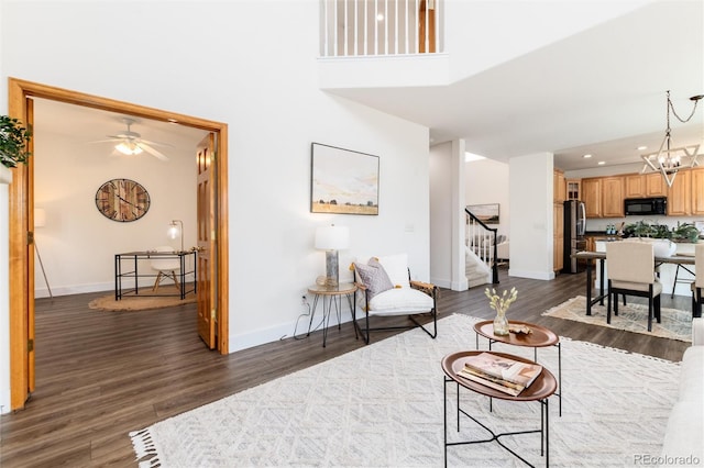 9610 S Dover Way, Littleton, CO 80127 - living room with stairway, recessed lighting, dark wood-style flooring, a chandelier, and a high ceiling