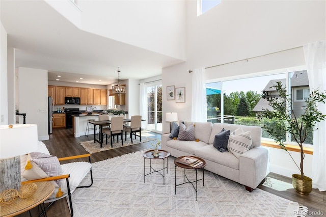 9610 S Dover Way, Littleton, CO 80127 - living area with wood finished floors, a chandelier, and recessed lighting