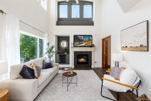 9610 S Dover Way, Littleton, CO 80127 - living area with a towering ceiling, wood finished floors, and a premium fireplace