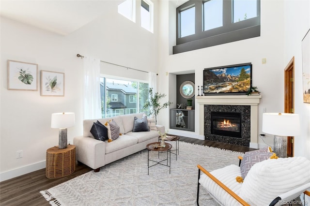 9610 S Dover Way, Littleton, CO 80127 - living area featuring wood finished floors, a towering ceiling, and a premium fireplace