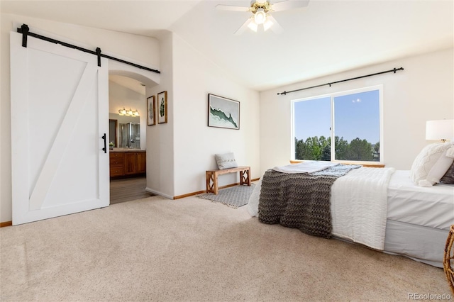 9610 S Dover Way, Littleton, CO 80127 - carpeted bedroom with lofted ceiling, a barn door, ensuite bath, and a ceiling fan