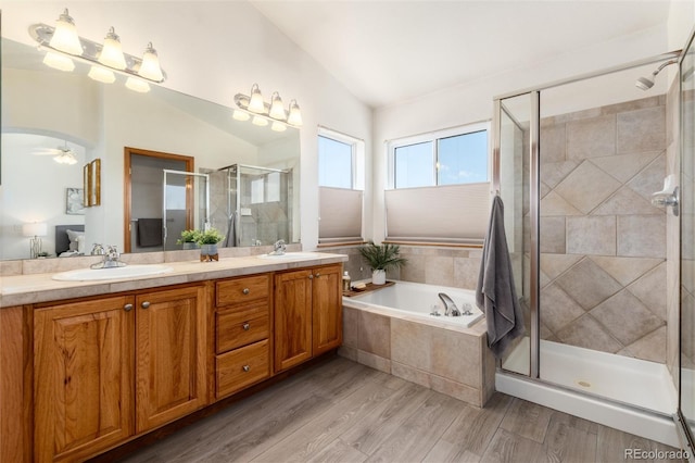 9610 S Dover Way, Littleton, CO 80127 - full bath with double vanity, a stall shower, a garden tub, lofted ceiling, and ceiling fan