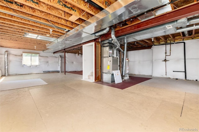 9610 S Dover Way, Littleton, CO 80127 - below grade area featuring heating unit, gas water heater, and stairs