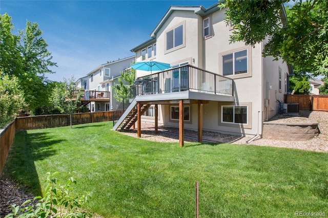 9610 S Dover Way, Littleton, CO 80127 - rear view of house with stucco siding, a fenced backyard, a wooden deck, and stairway