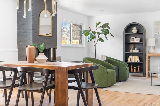 dining room with built in features and wood finished floors