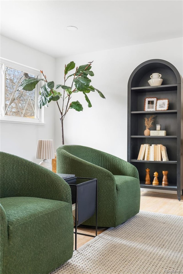 living area with wood finished floors and built in features