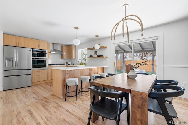 dining space featuring light wood-style floors