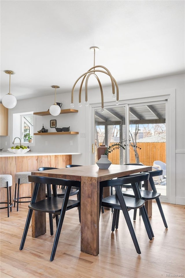 dining space featuring light wood-style flooring