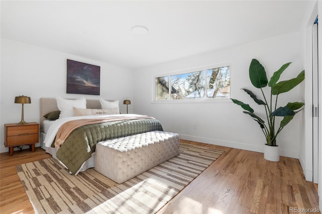 bedroom featuring baseboards and wood finished floors