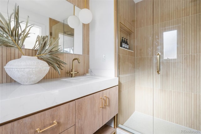 full bathroom featuring a tile shower and vanity