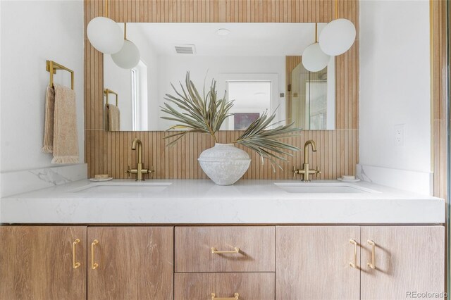 details with visible vents, a sink, and double vanity