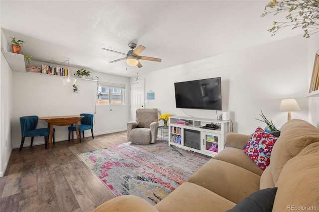 living room with hardwood / wood-style floors and ceiling fan