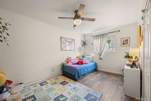 bedroom featuring light hardwood / wood-style flooring and ceiling fan