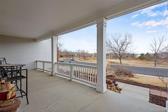 view of patio featuring outdoor dining area and covered porch