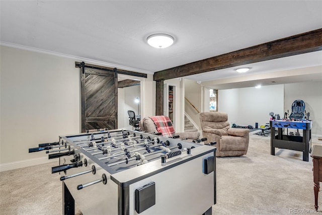 recreation room featuring a barn door, baseboards, ornamental molding, carpet floors, and beam ceiling